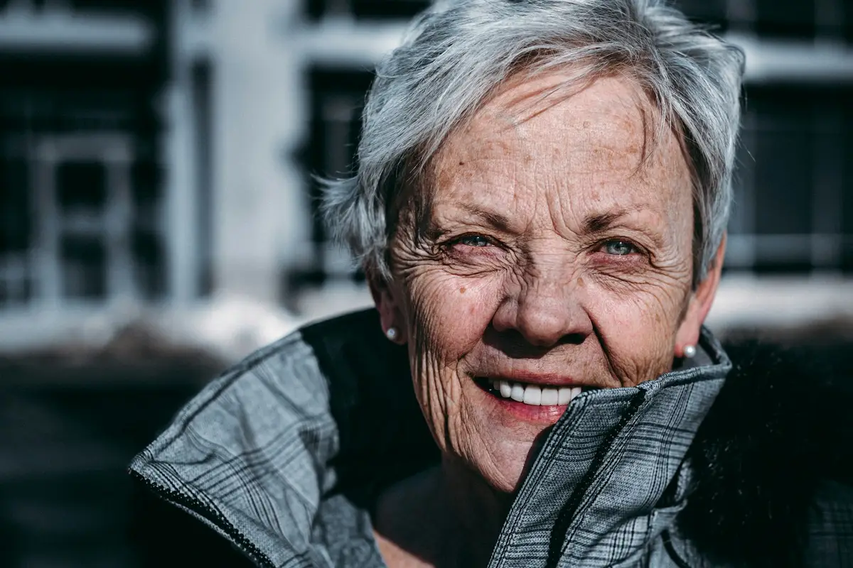 Portrait of an older woman outdoors, smiling. Not a client of Immaculate Heart Care and Cleaning Services.